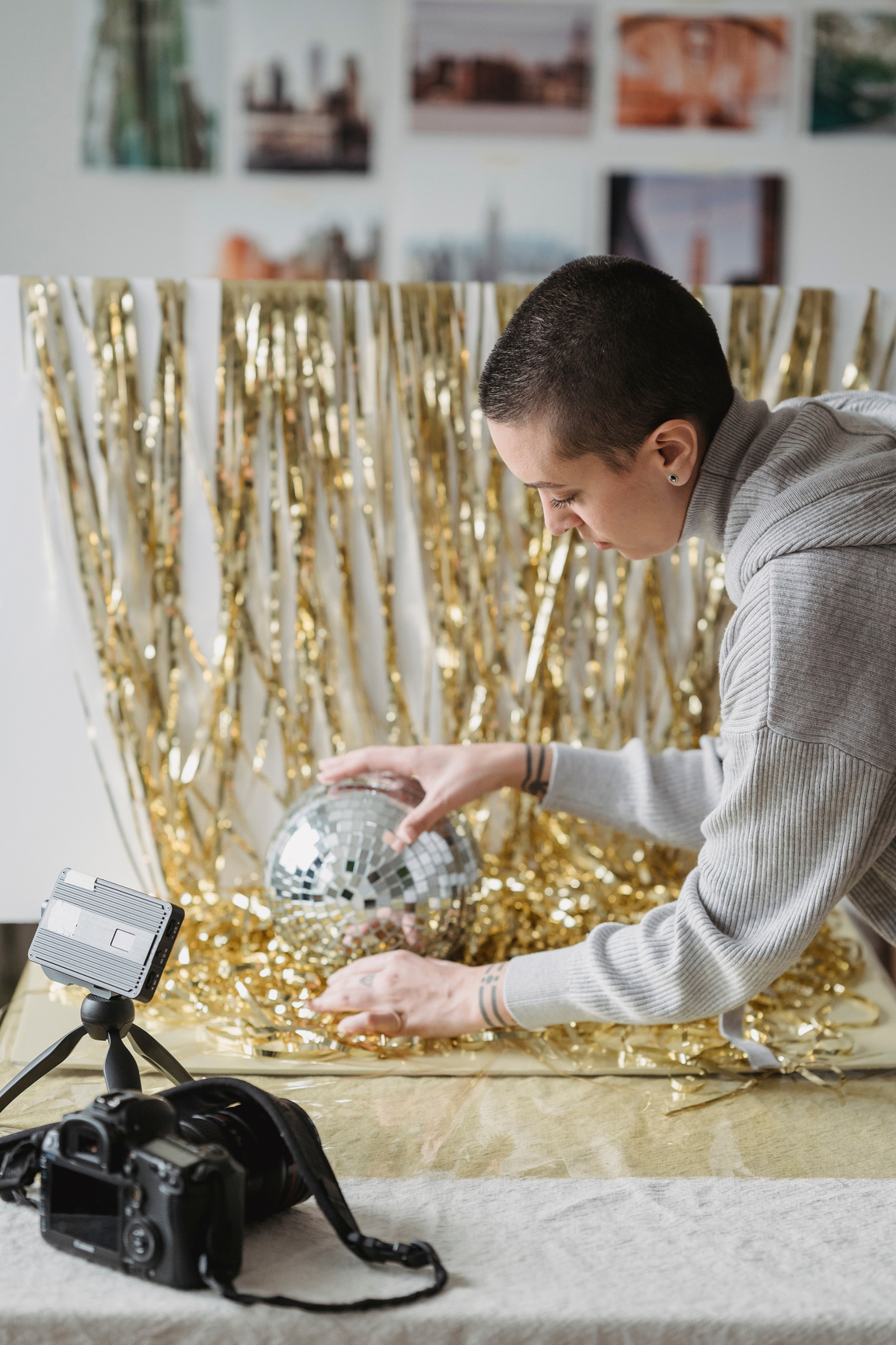 Focused woman placing party ball on tinsel