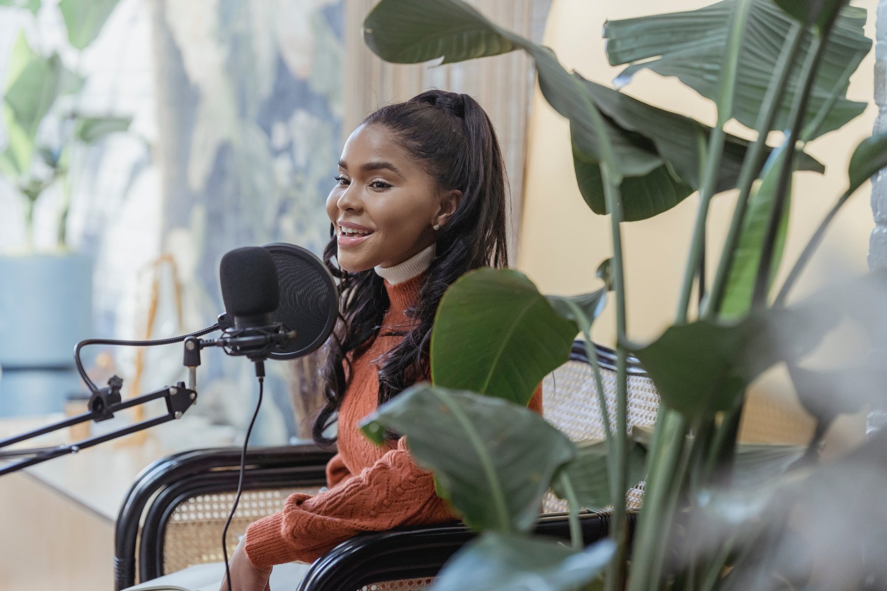 Happy young black woman singing during radio program