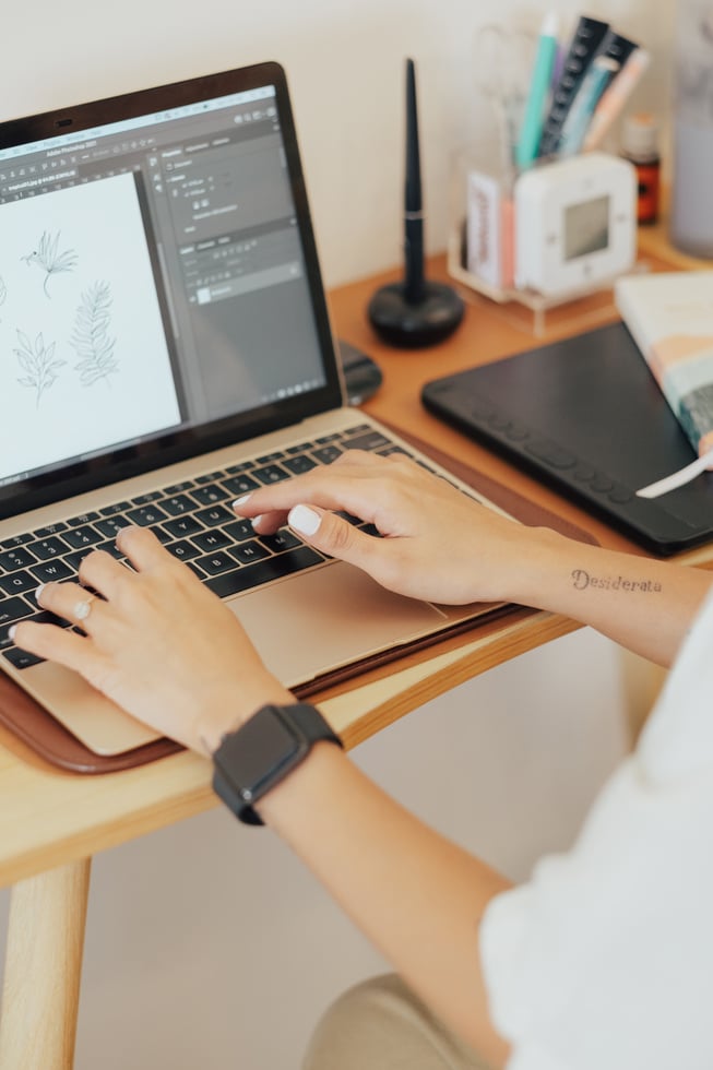 Female Designer Working with Laptop in Studio