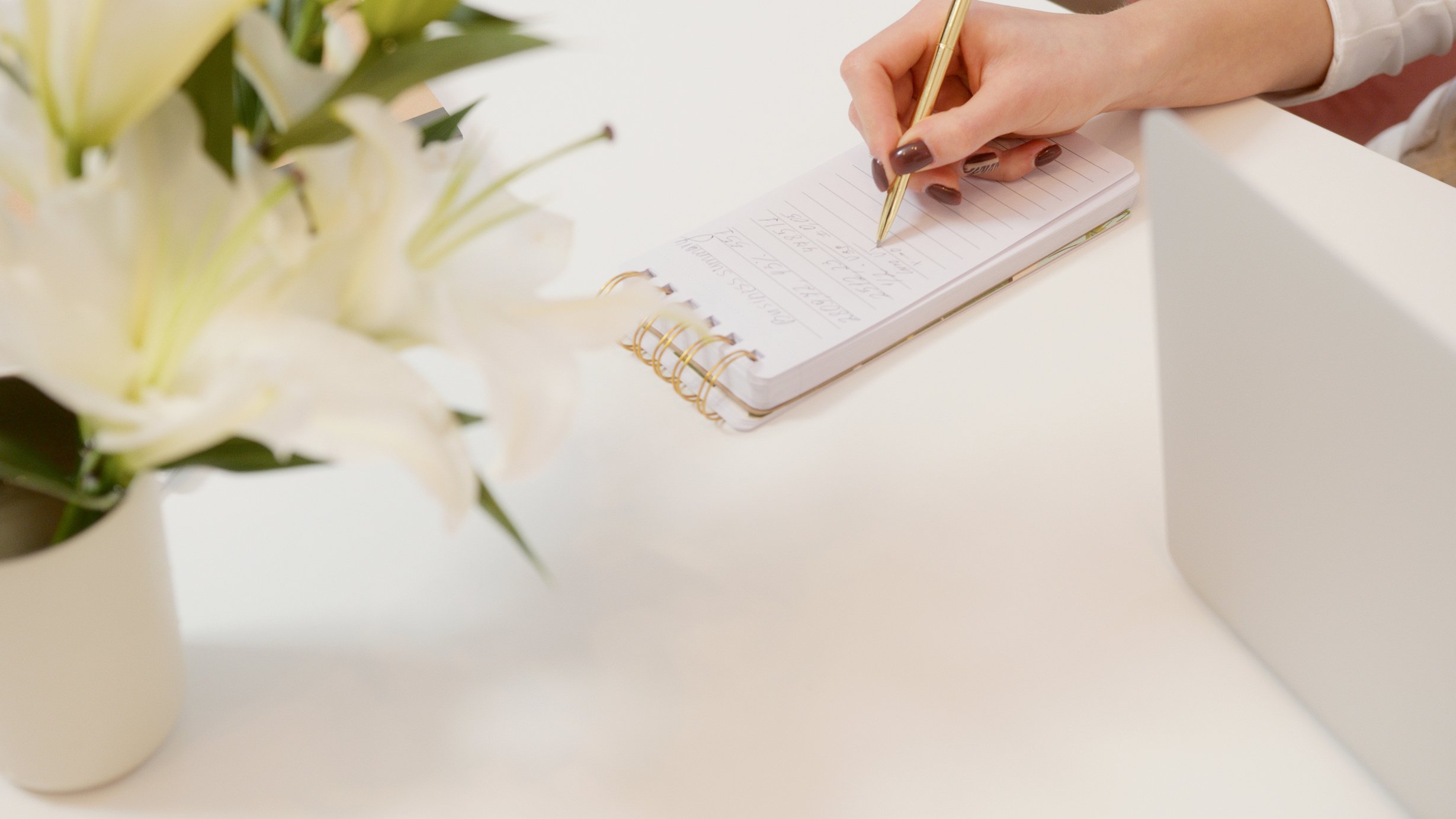  A Person Writing on a Notepad