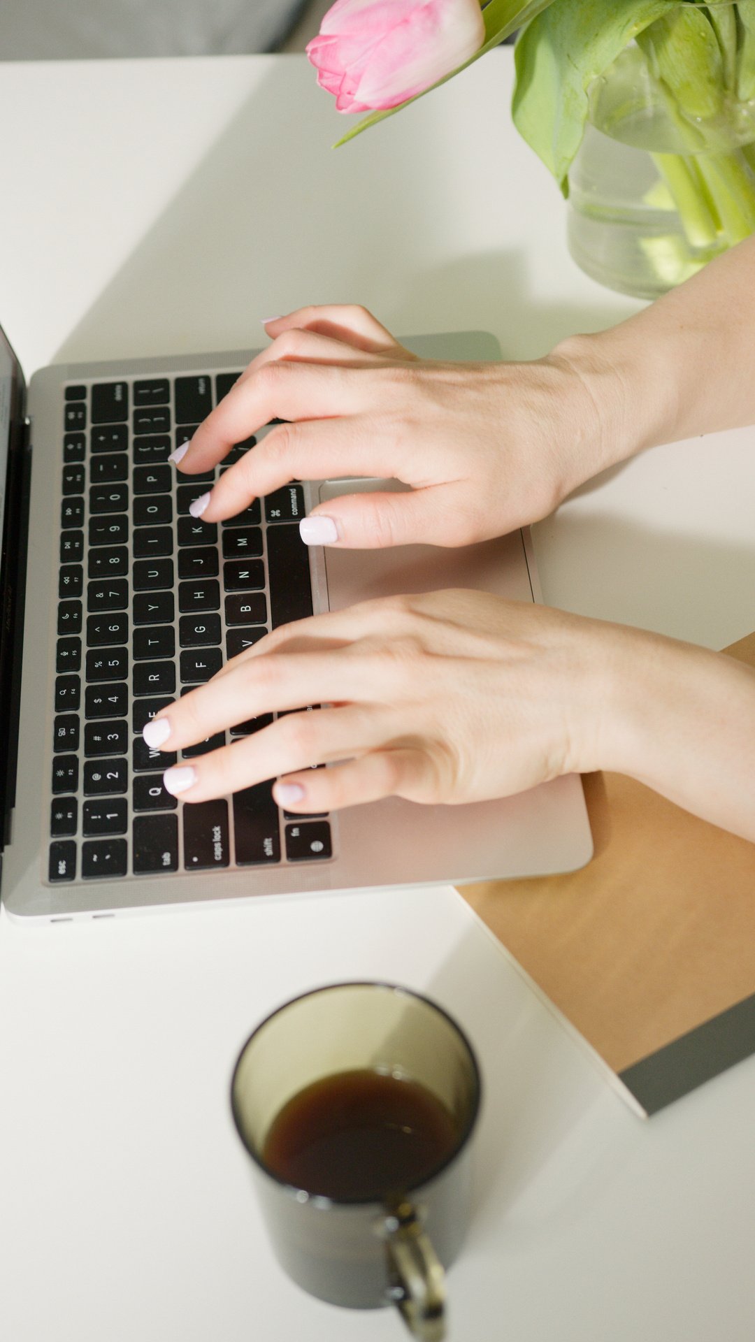 A Person Typing on a Black and White Laptop Keyboard